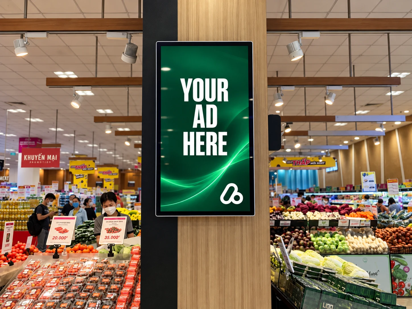 Portrait retail media display beside fresh produce at AEON