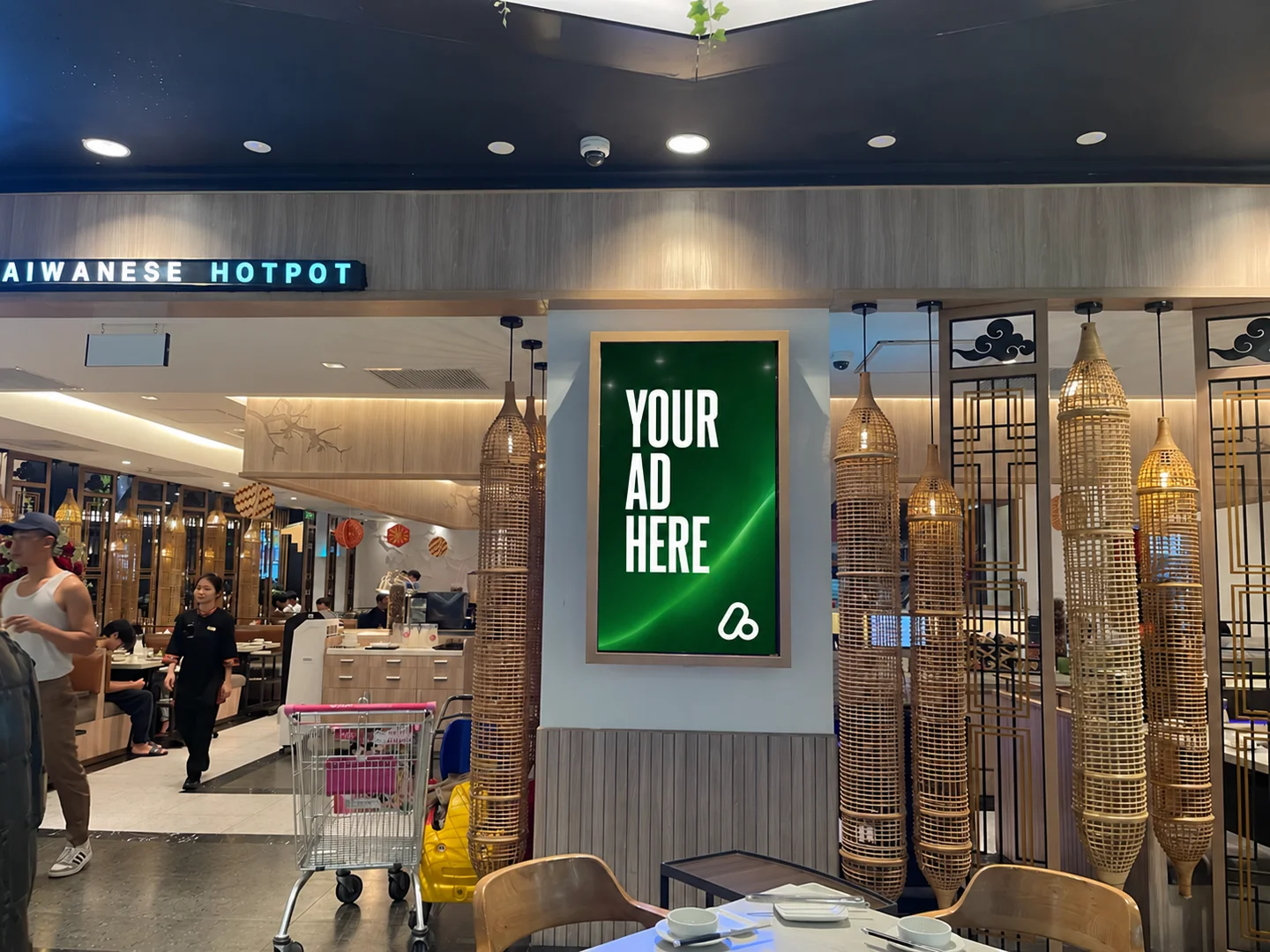 Digital advertising display beside Golden Gate restaurant seating