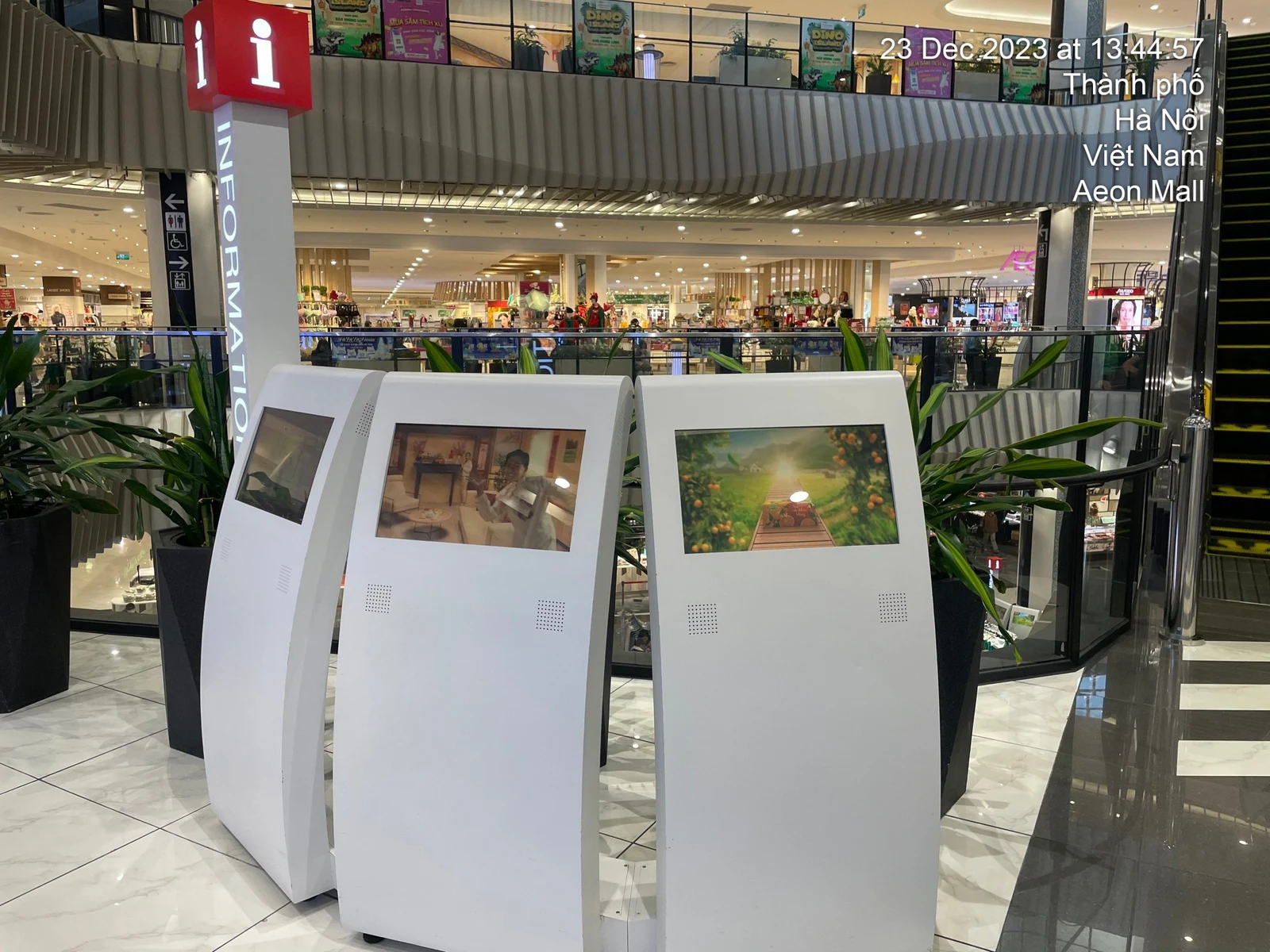 Indoor information kiosks beside an escalator at AEON Mall Hà Đông