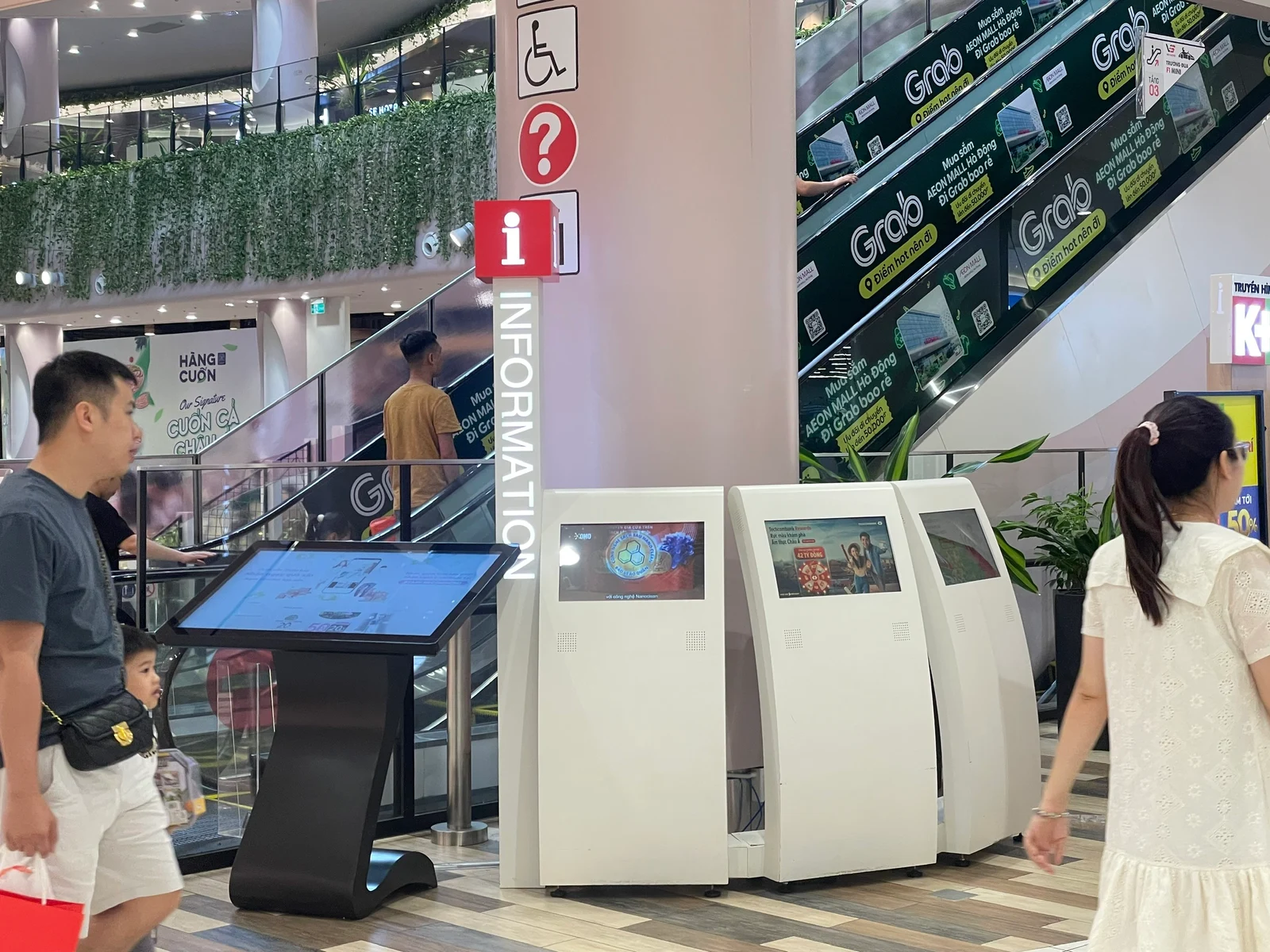 Shopper using an indoor wayfinding touchscreen at AEON Mall Hà Đông