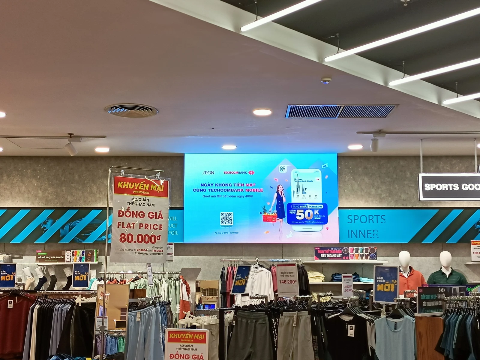 Digital retail media display above the AEON clothing department