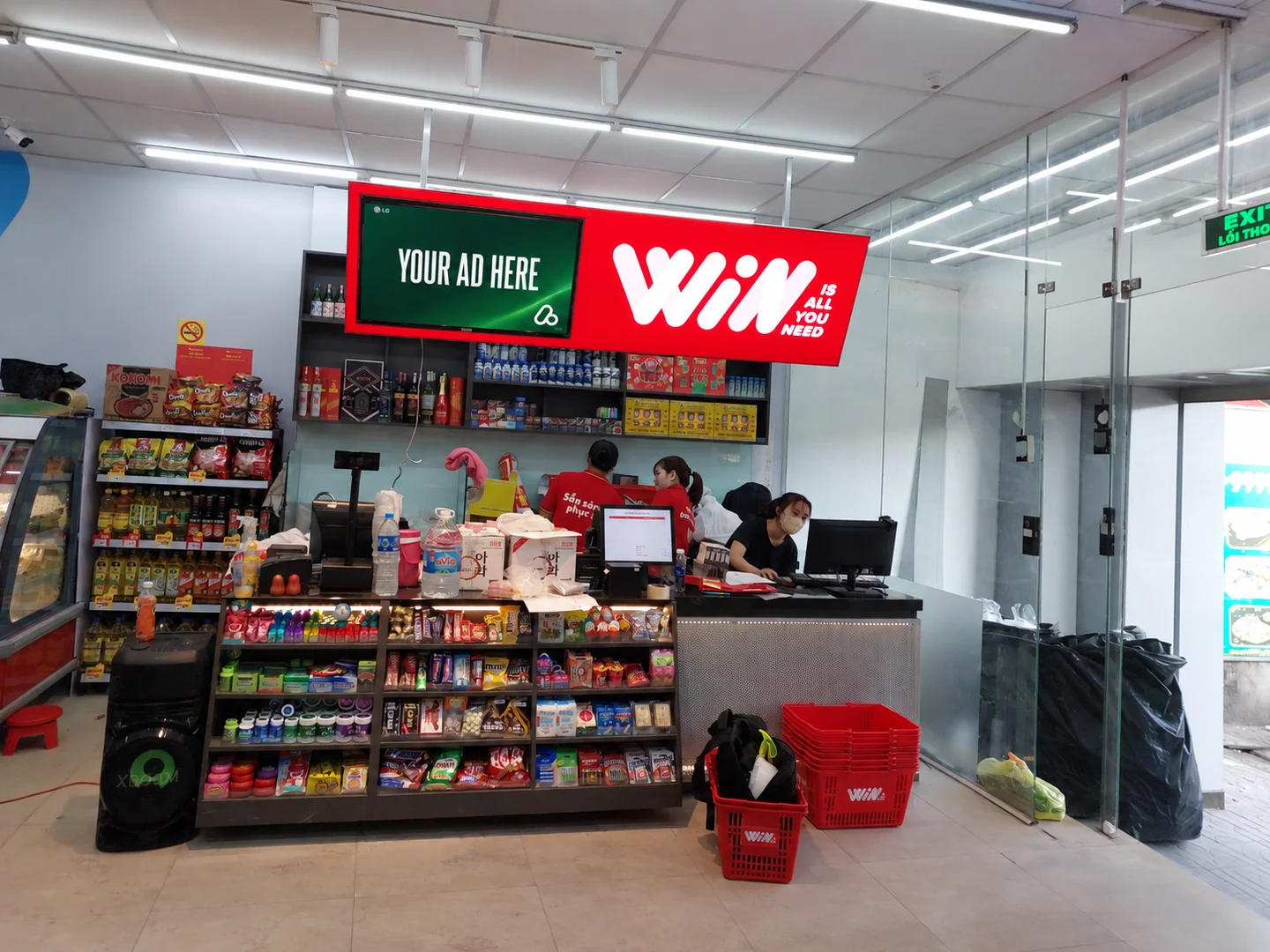 Retail media display above a WinMart checkout counter